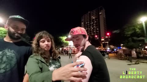 Magnets sticking to vaccinated people in downtown street experiment.