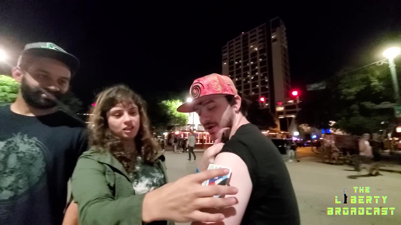 Magnets sticking to vaccinated people in downtown street experiment.