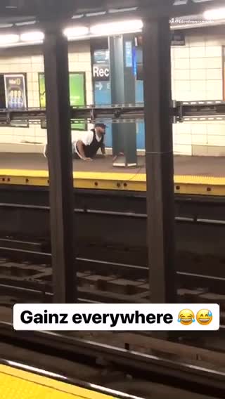 Gainz every where man does push ups in train station