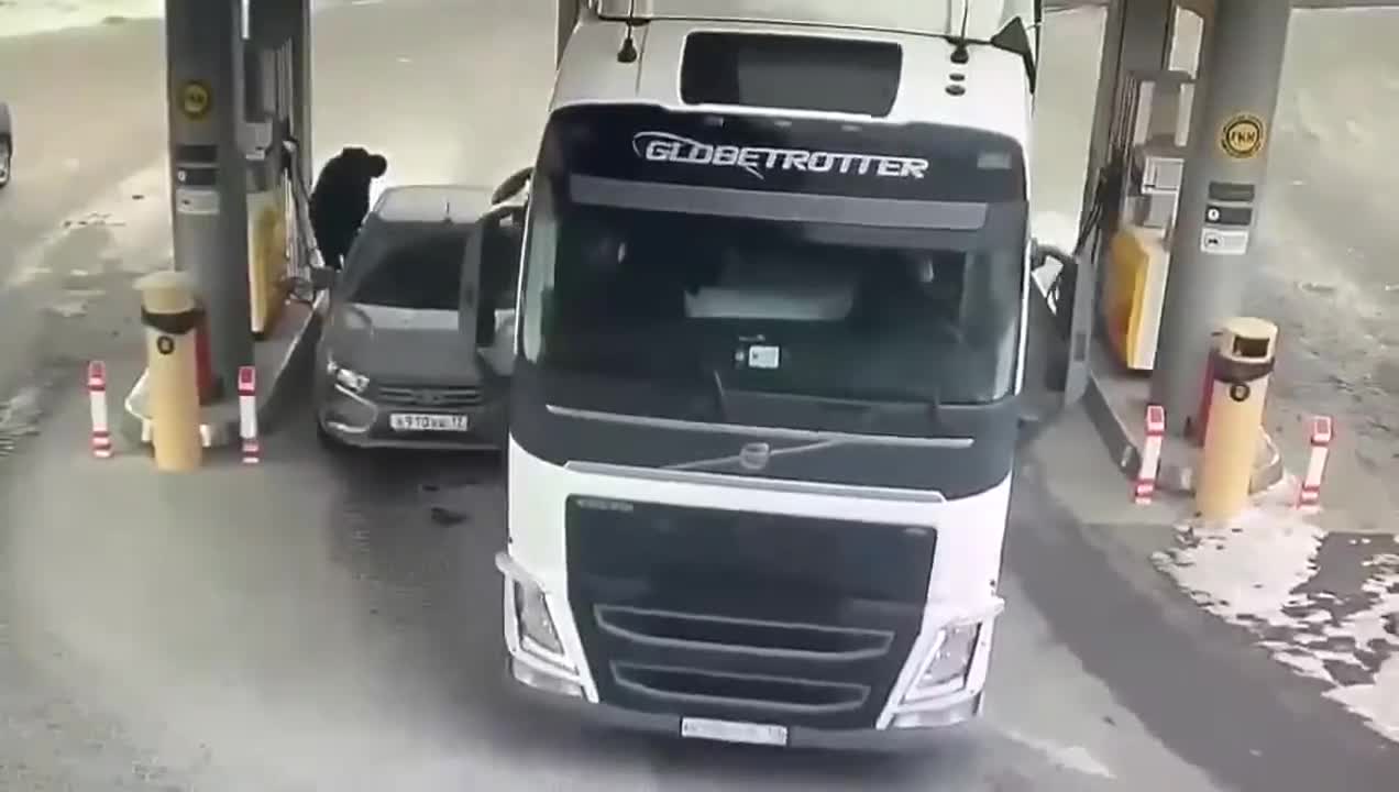 Man trying to protect his car to avoid getting crushed by a truck