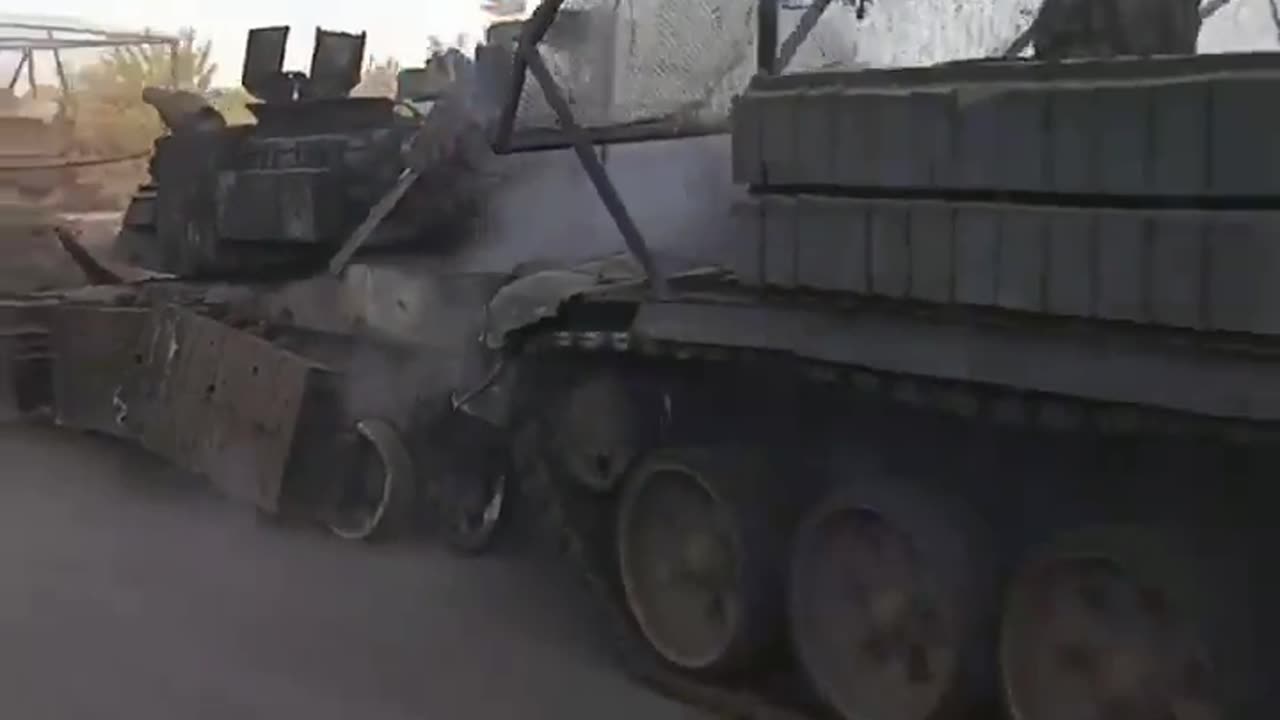 Russians tow a destroyed Ukrainian Abrams tank