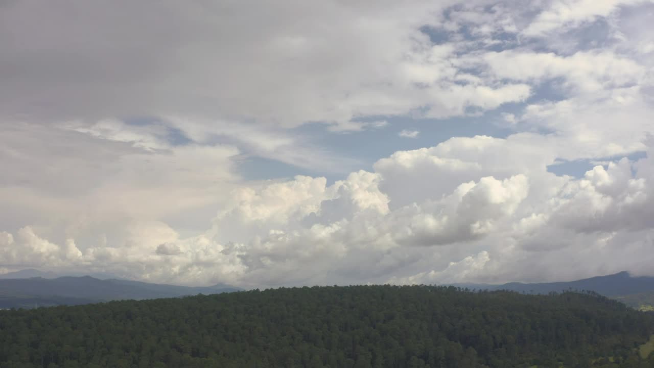 Cloud filled sky above a hill