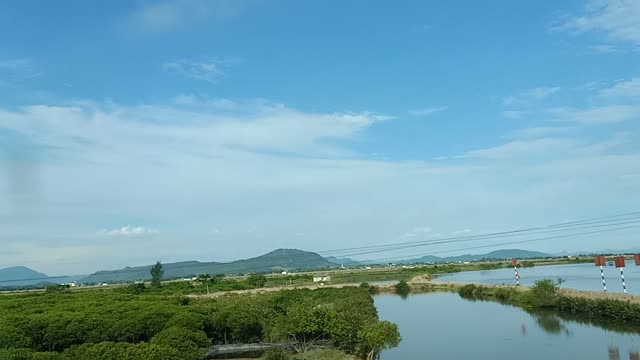 mountain clouds and green fields