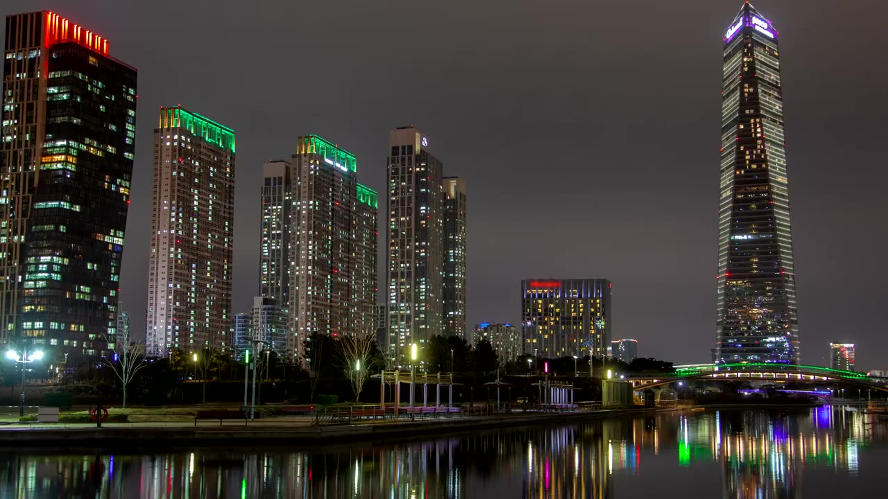 Huge skyscrapers illuminated in colors at night