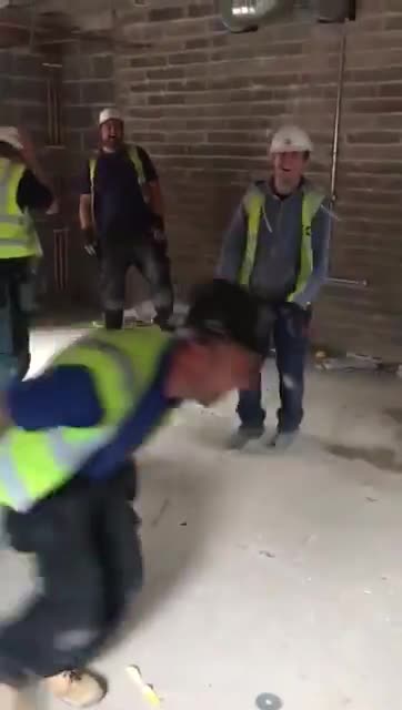 Kidding with Colleague on Construction Site.