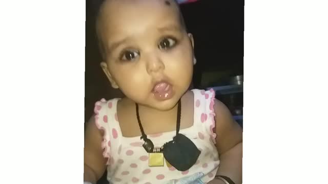 Indian baby trying to first smile face