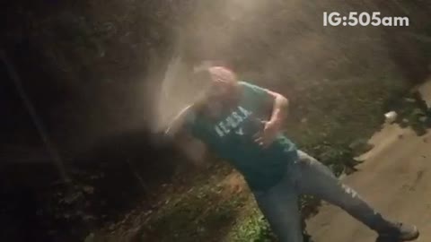 Guy in green shirt cracks beer over head and chugs beer