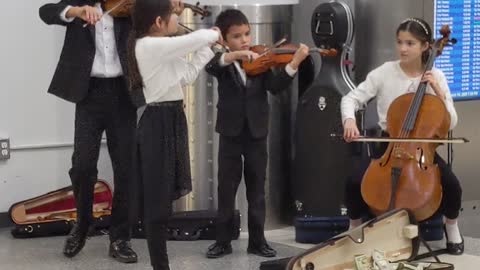 Talented Young Orchestra Playing in Lobby