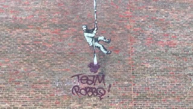 Banksy mural vandalised with rival's name