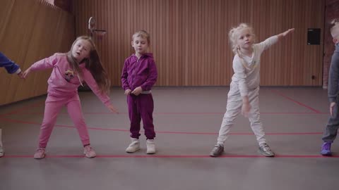 Student Girls Stretching in a Gymnastic Class