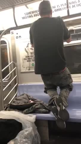 Homeless man does pull ups on subway train