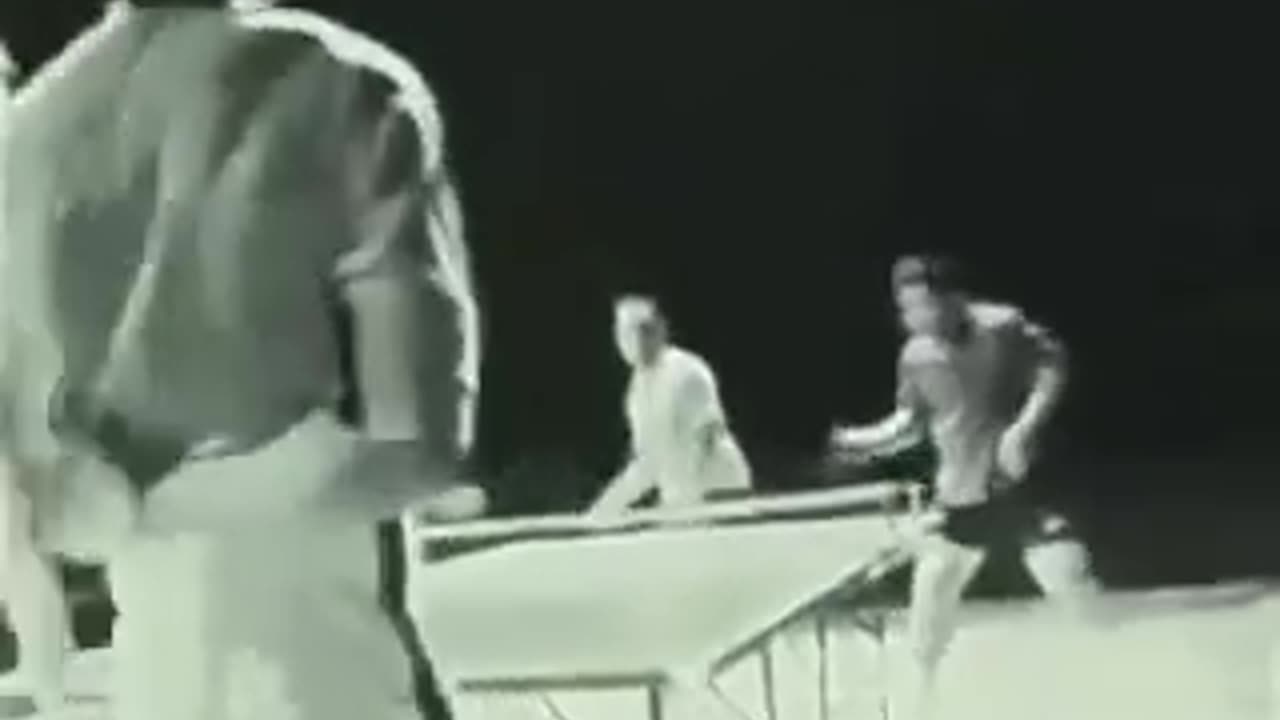 Bruce Lee beats two professional table tennis players, using only the nunchucks