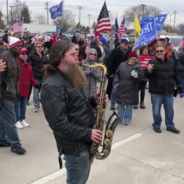 Saxophonist Plays National anthem in street during Milwaukee protest