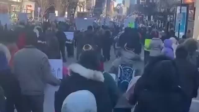 Protestors march in Boston against vaxx mandates and vaxx passports.