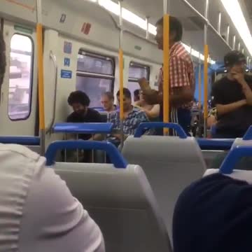 Man in red flannel sings on subway