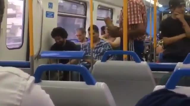 Man in red flannel sings on subway