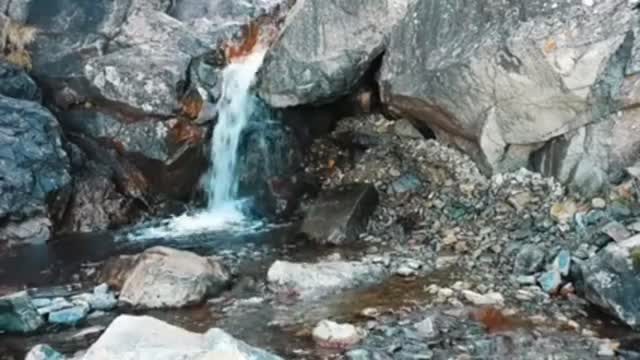 Small waterfalls with rocks around it