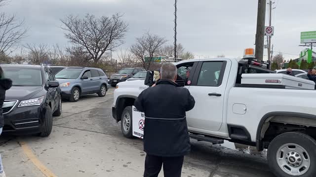 City of Toronto employee interacts with protestors