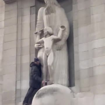 Man climbs onto the BBC building smashing up the Eric Gill pedophile statue