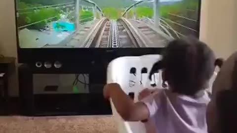 Baby girl driving her own train