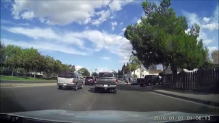 Car tries to squeeze by stopped traffic and gets tapped by truck