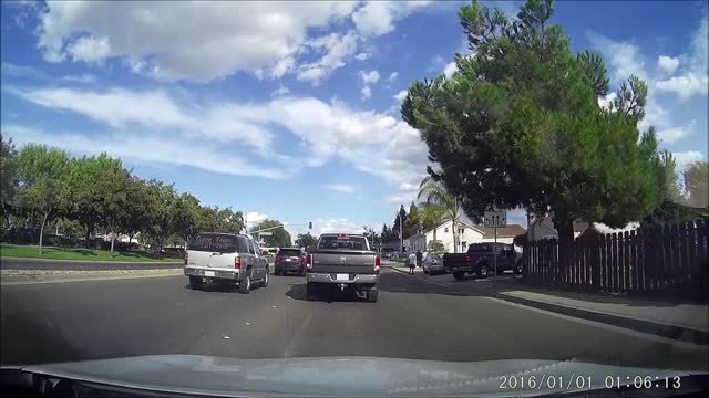 Car tries to squeeze by stopped traffic and gets tapped by truck