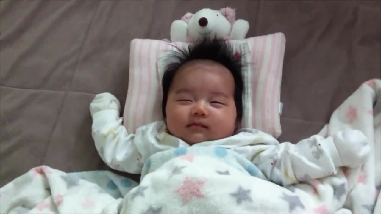 Cute little Asian baby sleeping and smiling