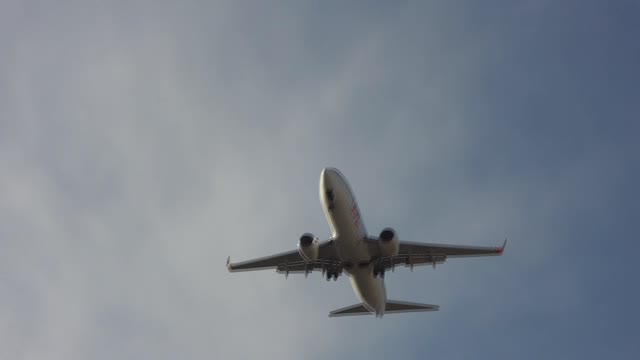 AIRPLANE FLYING LOW OVER SHOPPING