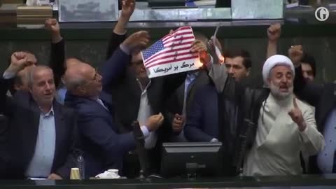 Iranian lawmakers set paper US flag on fire