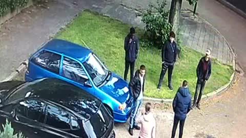 Girl confronts group boys that are sitting on her brother's car