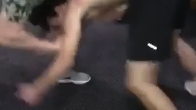 Two friends wrestle, one in green shirt wins