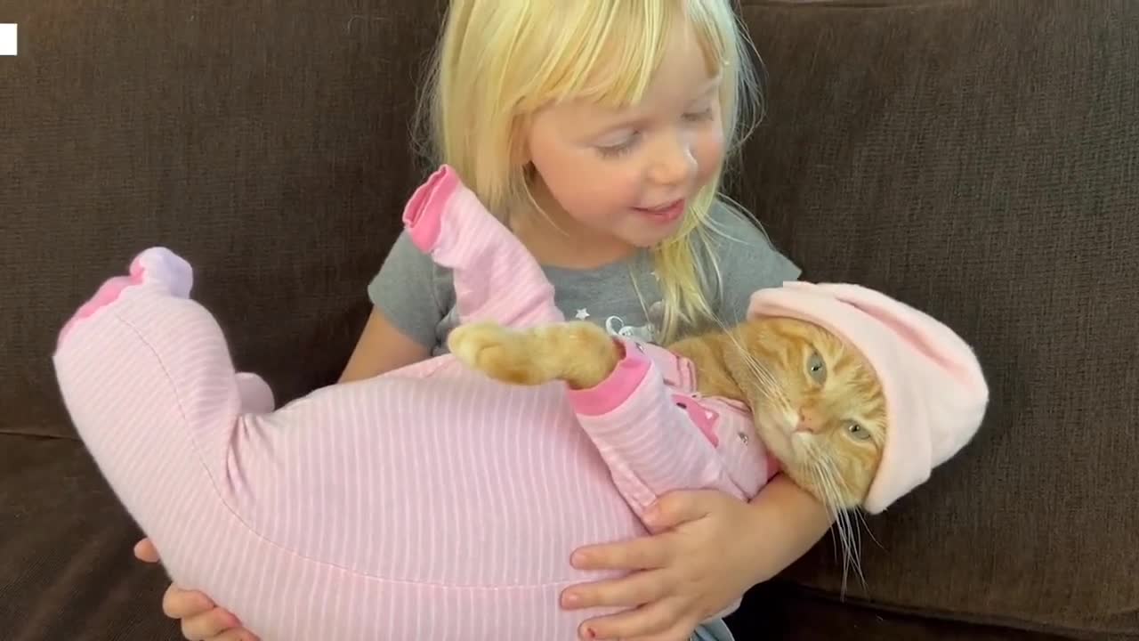 Sweet girl sings lullaby to cat wearing pajamas