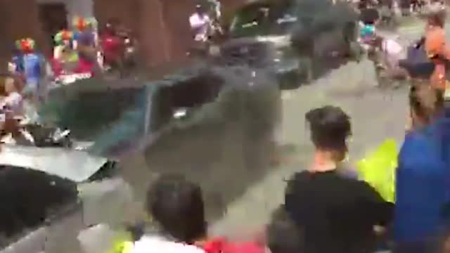 trump motivated white suppremacist racist, crashes though crowd with dodge challenger.