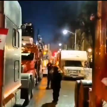Thousands of trucks slowly arrive in Ottawa, honking very loudly in front of the Parliament building