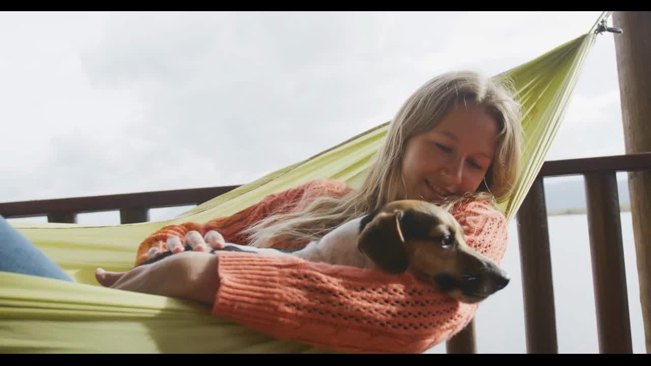 Caucasian couple spending time at home together, playing with dogs