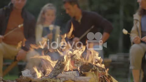 Pull Focus Shot from Father, Grandfather and Daughter to Campfire