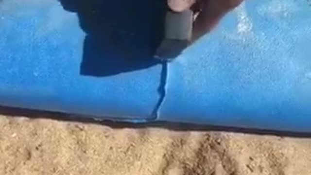 Good as new guy repairs blue surfboard stapler