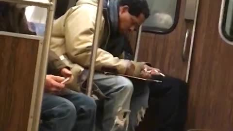 Man smoking and drawing on train