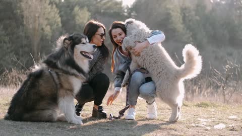 Women holding their dogs