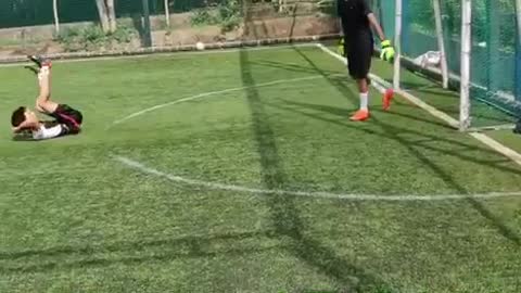 Slow motion kid misses kicking green soccer ball
