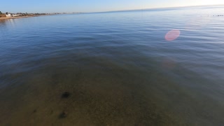 Water lapping against the shore. A calm sea on a sunny day. GoPro