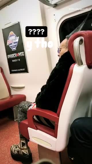 Man on train wearing cheetah print and english flag