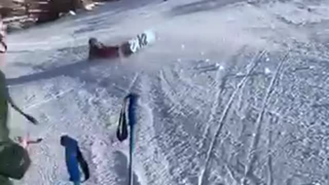 Snowboarder black helmet tries to 360 spin lands on head