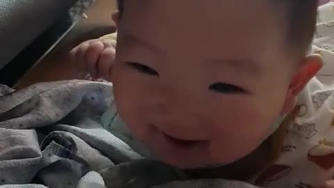 This is a video of a brightly smiling baby.