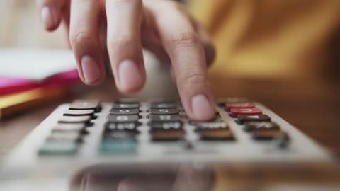 Woman's Hand Pressing Calculator