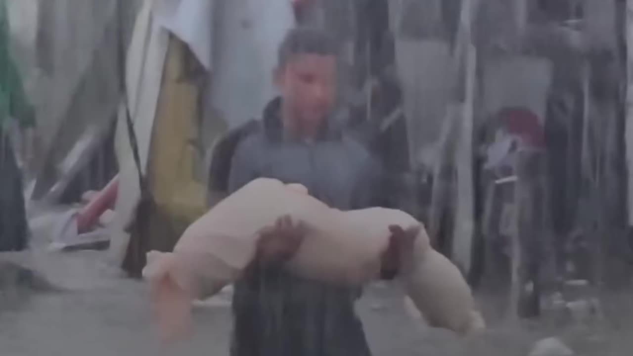 An indicative scene of a young man carrying a girl who was killed in Gaza