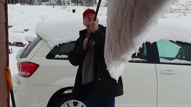 Big wave of snow creeping off roof