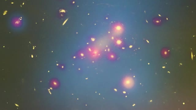 Stars and galaxies in space through a yellow cloud