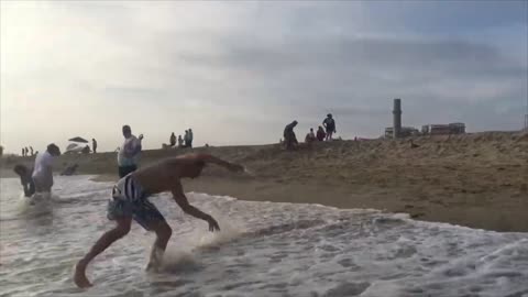 Guy Slips Into Water Trying to Flip on the Beach