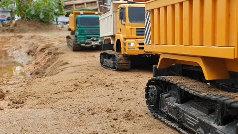 3 RC dump trucks are walking towards the sand mining site